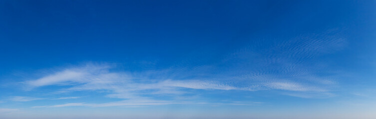 Fototapeta premium Blue Sky background with tiny Clouds. Panorama background