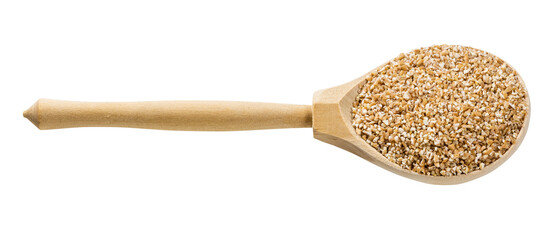 wooden spoon with uncooked wheat groats isolated