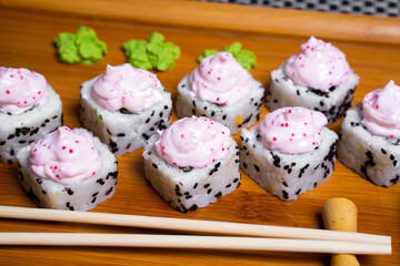 Philadelphia roll sushi with salmon, shrimps, avocado, cream cheese. Sushi menu. Japanese food..Sushi roll isolated on white close up