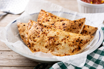 Traditional Chilean empanadas on rustic wooden table