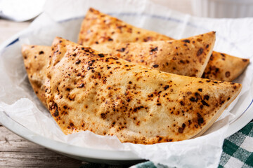 Traditional Chilean empanadas on rustic wooden table. Close up