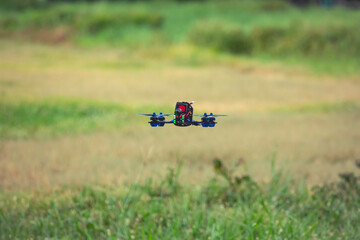 Drone copter fast flying with digital camera in field