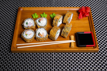 Philadelphia roll sushi with salmon, shrimps, avocado, cream cheese. Sushi menu. Japanese food..Sushi roll isolated on white close up