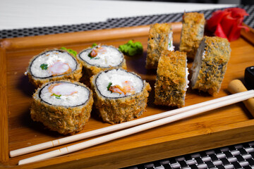 Philadelphia roll sushi with salmon, shrimps, avocado, cream cheese. Sushi menu. Japanese food..Sushi roll isolated on white close up