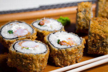 Philadelphia roll sushi with salmon, shrimps, avocado, cream cheese. Sushi menu. Japanese food..Sushi roll isolated on white close up