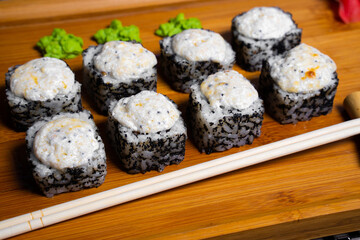 Philadelphia roll sushi with salmon, shrimps, avocado, cream cheese. Sushi menu. Japanese food..Sushi roll isolated on white close up