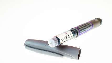Insulin pen injector.  Insulin pen fill with needle on white background. Diabetes Day.