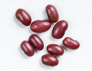 several raw mexican red beans close up on gray