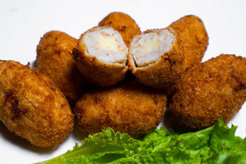 Baked chicken wings with sesame seeds with herbs and sweet sauce in a white box on the table
