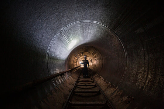 Fototapeta Working male inspection weld underground of equipment tunnel