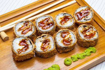 Philadelphia roll sushi with salmon, shrimps, avocado, cream cheese. Sushi menu. Japanese food..Sushi roll isolated on white close up