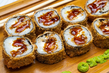 Philadelphia roll sushi with salmon, shrimps, avocado, cream cheese. Sushi menu. Japanese food..Sushi roll isolated on white close up