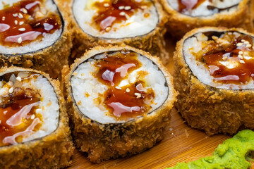 Philadelphia roll sushi with salmon, shrimps, avocado, cream cheese. Sushi menu. Japanese food..Sushi roll isolated on white close up