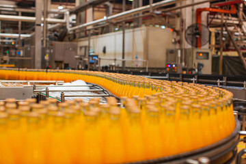 Beverage factory interior. Conveyor flowing with bottles for juice