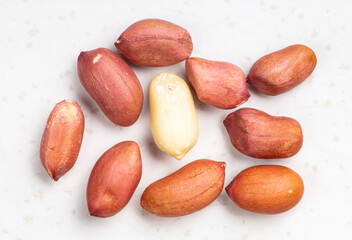 several shelled peanuts close up on gray