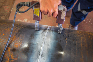 Male worker test steel pipeline butt weld carbon background white contrast