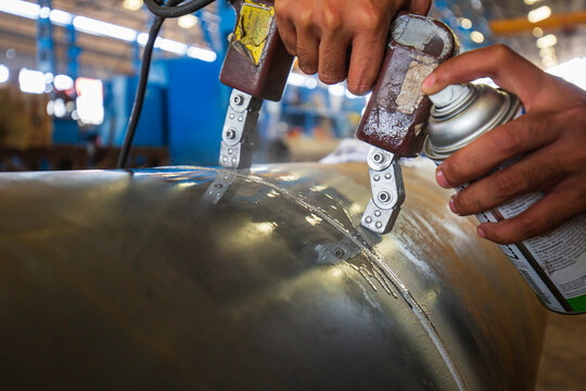 Male worker test steel pipeline butt weld carbon background white contrast