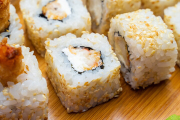 Philadelphia roll sushi with salmon, shrimps, avocado, cream cheese. Sushi menu. Japanese food..Sushi roll isolated on white close up