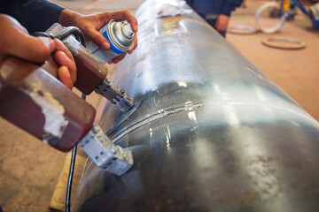 Male worker test steel pipeline butt weld carbon background white contrast