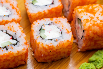 Philadelphia roll sushi with salmon, shrimps, avocado, cream cheese. Sushi menu. Japanese food..Sushi roll isolated on white close up