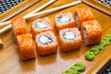 delicious sushi rolls on a wooden board