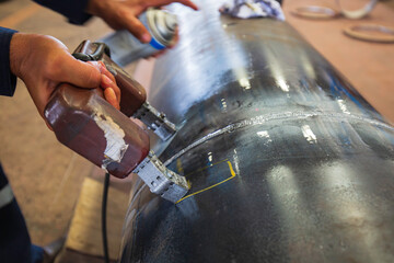 Male worker test steel pipeline butt weld carbon background white contrast