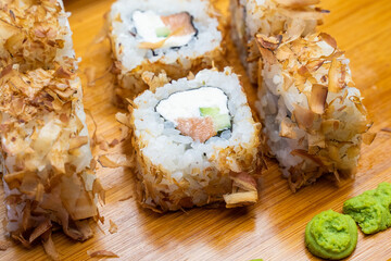 Philadelphia roll sushi with salmon, shrimps, avocado, cream cheese. Sushi menu. Japanese food..Sushi roll isolated on white close up