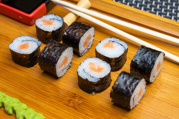 Philadelphia roll sushi with salmon, shrimps, avocado, cream cheese. Sushi menu. Japanese food..Sushi roll isolated on white close up