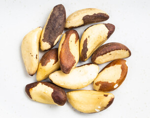 view of pile of raw brazil nuts close up on gray