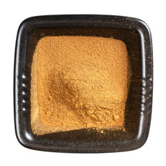 top view of cinnamon powder in black bowl isolated