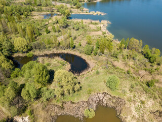 Fototapeta na wymiar Lake in the forest in spring. Aerial drone view.