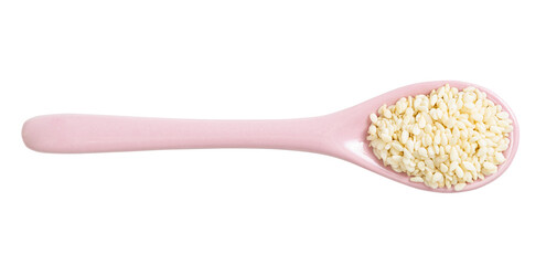 ceramic spoon with raw white sesame seeds isolated