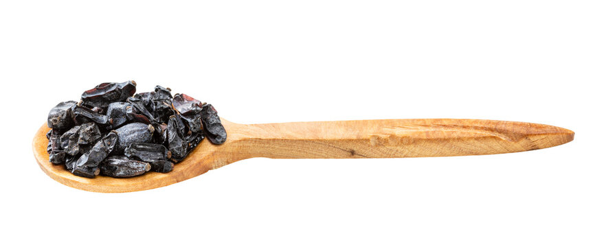 wooden spoon with black barberry fruits isolated