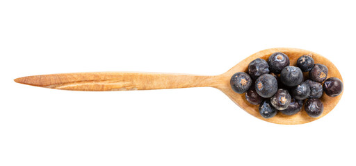 top view of wood spoon with dried juniper berries