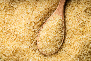 pile of demerara brown cane sugar with spoon