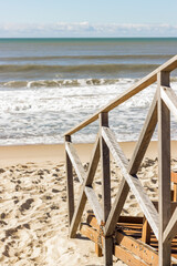 Landscape. Deck Bridge over the sand at the beach with the on background