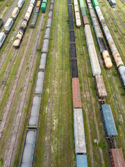 Freight trains on railway tracks. Aerial drone top view. Sunny spring day.