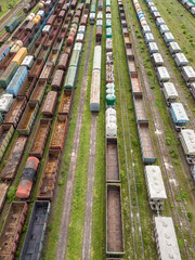 Freight trains on railway tracks. Aerial drone top view. Sunny spring day.