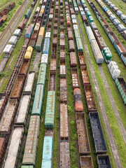 Freight trains on railway tracks. Aerial drone top view. Sunny spring day.