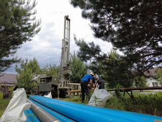 Europe, Kiev region, Ukraine - June 2021: An engineer is drilling a water well. Drilling rig worker...
