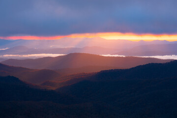 Cascading light shining down into the Blue Ridge Mountains along the Blue Ridge Parkway near Asheville, North Carolina.