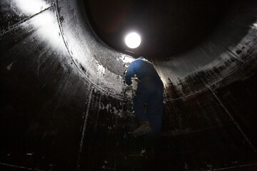 Male inside climb the stairway storage visual inspection tank - obrazy, fototapety, plakaty