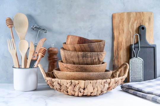 Stylish kitchen background with kitchen utensils on marble countertop, empty space for text, front view. Minimal cooking space with tableware.