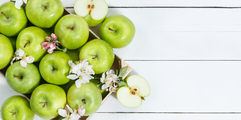 Apples fruits green apple fruit box on wooden board banner copyspace copy space with leaves and blossoms