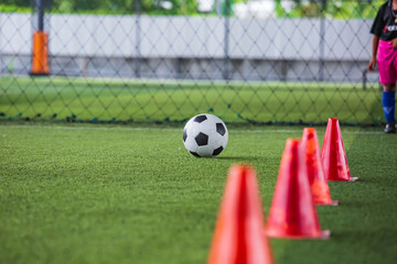 Obraz premium Soccer ball tactics cone on grass field with for training background