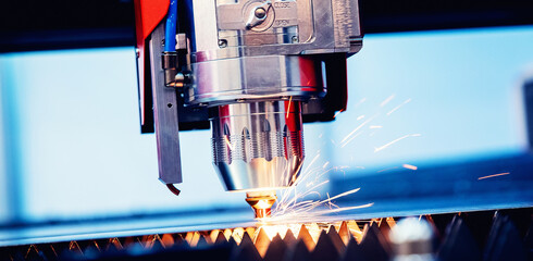 Concept banner background modern industrial technology. CNC Laser engraving cutting of heavy metal...