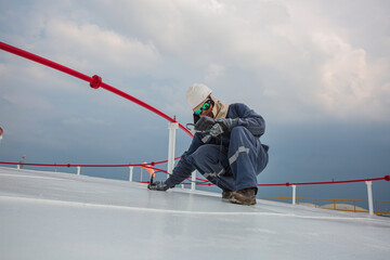 Male worker are for inspection  ultrasonic thickness roof plate top