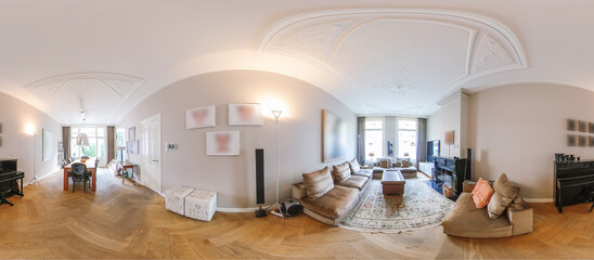 Wide angle 360 panorama of modern living room of flat with wooden floor and sofas and dining table...