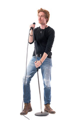 Joyful emotional rock music singer with microphone enjoying with closed eyes. Full body length isolated on white background.