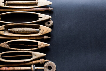 Old vintage primitive wood parts of shuttles hand weaving loom, antique wooden hand loom